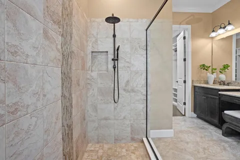 a bathroom with a granite countertop sink toilet and shower