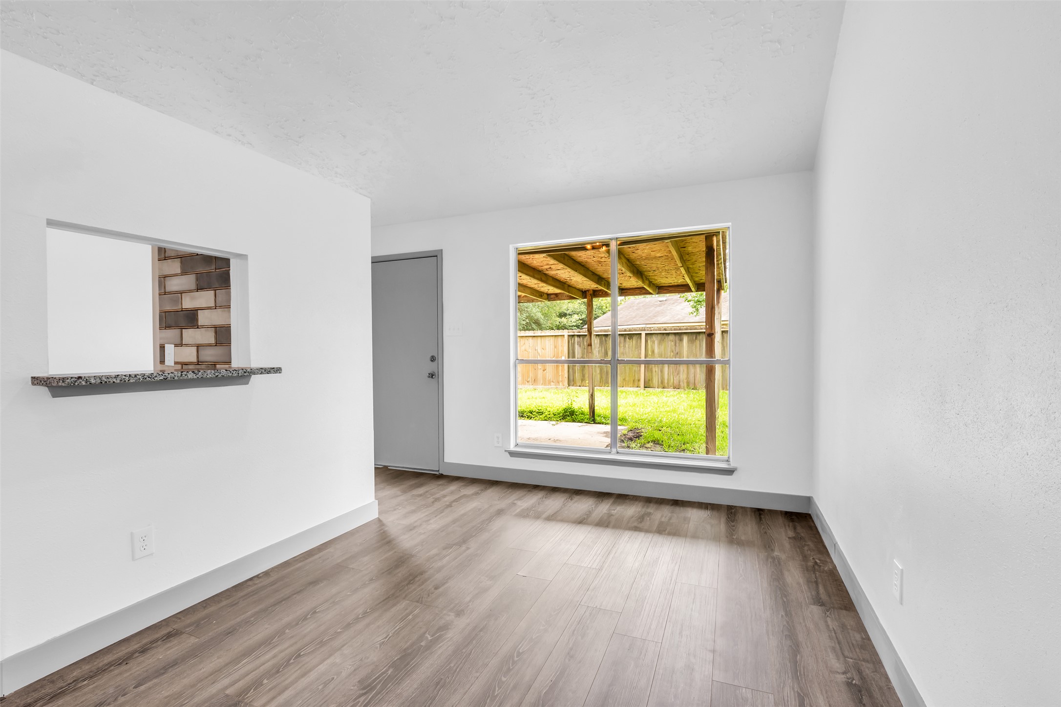 4631 Enchanted Rock Lane Spring, TX 77388 - Photo 4 of 12 Laminate flooring throughout this bright living space offers a seamless transition to the outdoors.