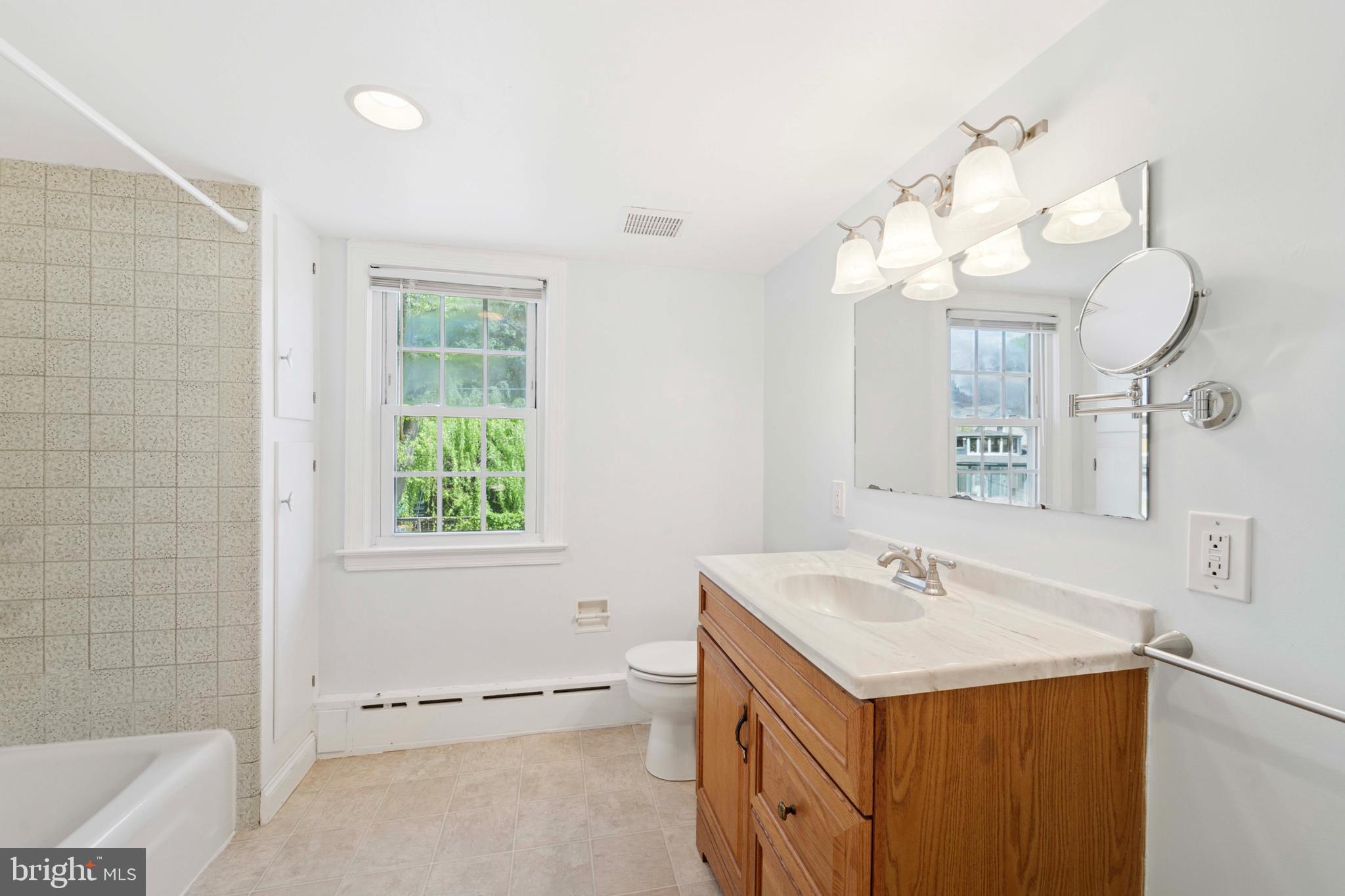307 Madison Road Springfield, PA 19064 - Photo 17 of 29 a bathroom with a sink a toilet and a mirror