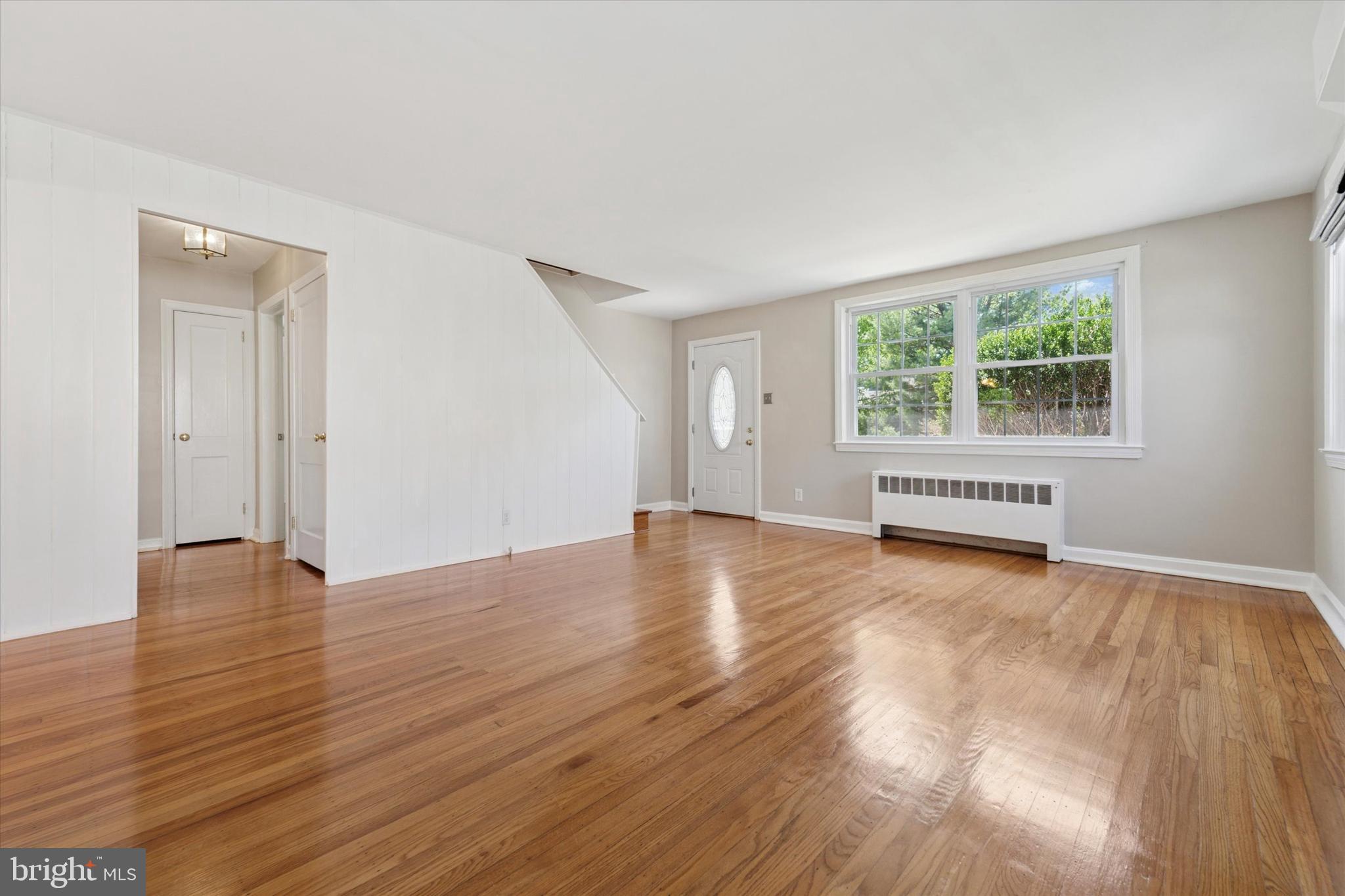 307 Madison Road Springfield, PA 19064 - Photo 3 of 29 a view of an empty room with wooden floor and a window