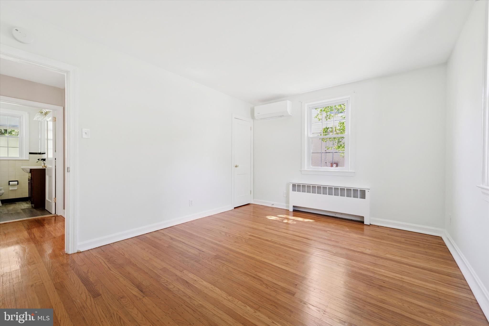 307 Madison Road Springfield, PA 19064 - Photo 10 of 29 a view of an empty room with wooden floor and a window