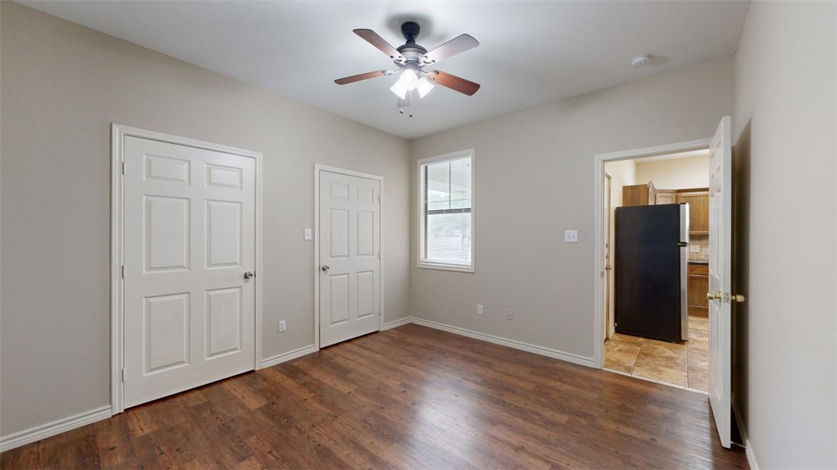 821 Ave B College Station, TX 77840 - Photo 13 of 33 wooden floor in an empty room with a window