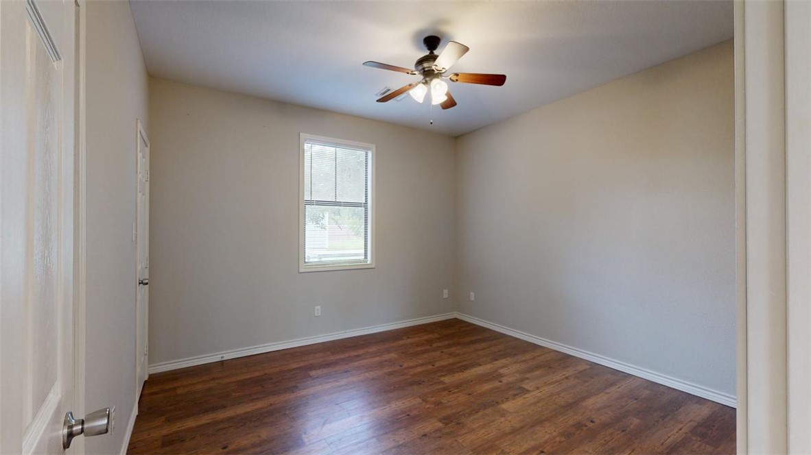 821 Ave B College Station, TX 77840 - Photo 14 of 33 wooden floor in an empty room with a window
