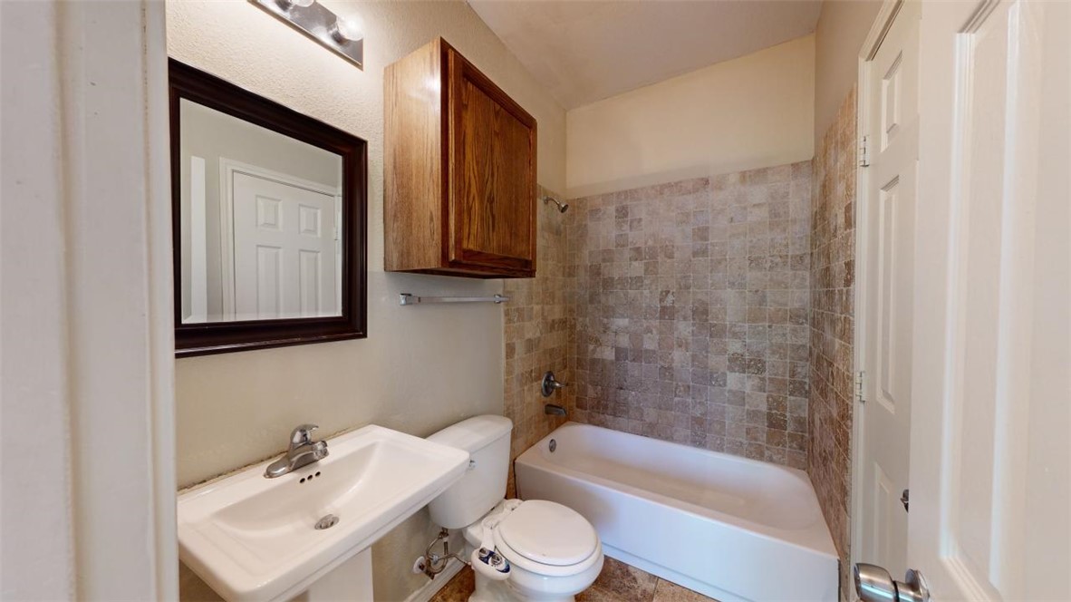 821 Ave B College Station, TX 77840 - Photo 16 of 33 a bathroom with a sink toilet and shower