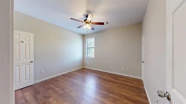 wooden floor in a room with a ceiling fan