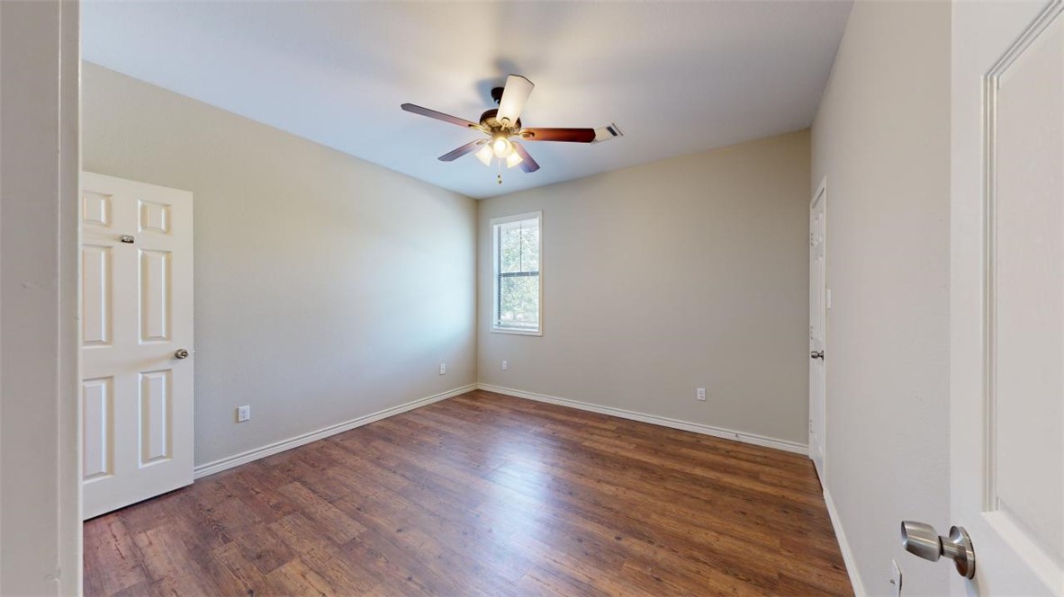 821 Ave B College Station, TX 77840 - Photo 20 of 33 an empty room with wooden floor fan and windows
