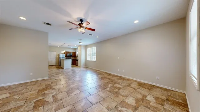 a view of a kitchen with a sink and a refrigerator