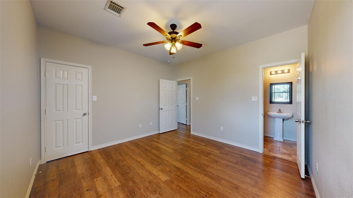 821 Ave B College Station, TX 77840 - Photo 21 of 33 wooden floor in a room with a ceiling fan