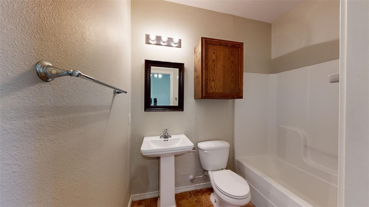 821 Ave B College Station, TX 77840 - Photo 25 of 33 a bathroom with a toilet sink and mirror