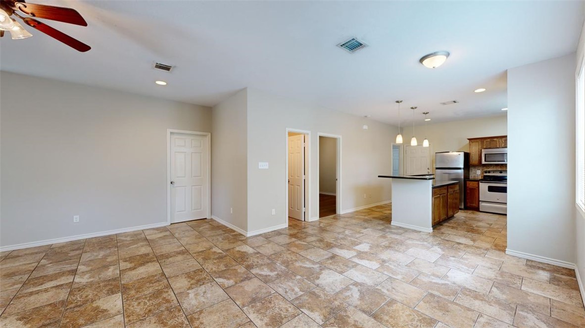 821 Ave B College Station, TX 77840 - Photo 5 of 33 a view of a kitchen with refrigerator and a sink