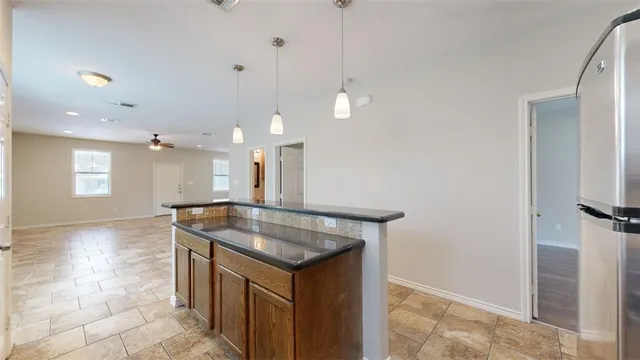 a kitchen with stainless steel appliances granite countertop a sink stove and microwave