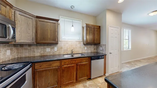 a view of kitchen with refrigerator and window