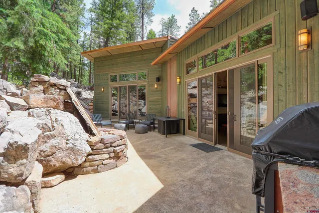 a view of a patio with chairs and potted plants
