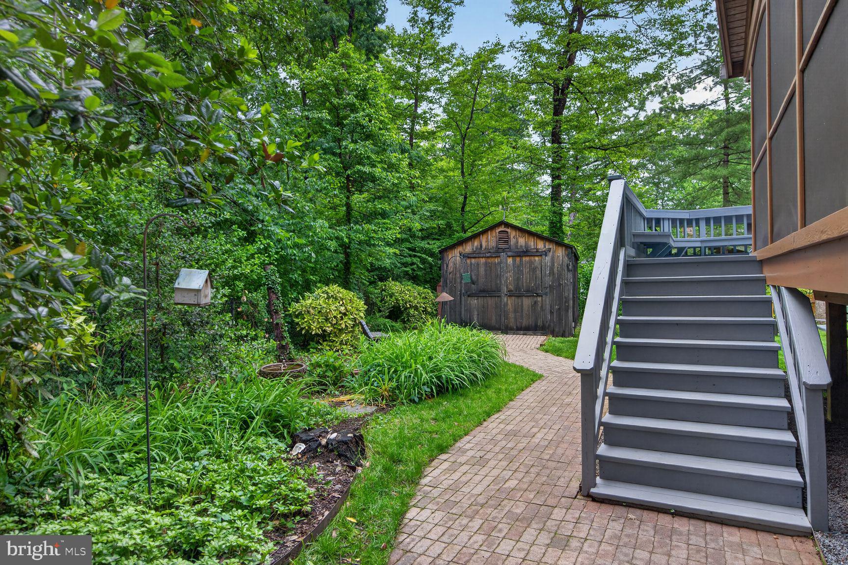 5024 Portsmouth Road Fairfax, VA 22032 - Photo 30 of 38 a view of a yard with wooden stairs and plants