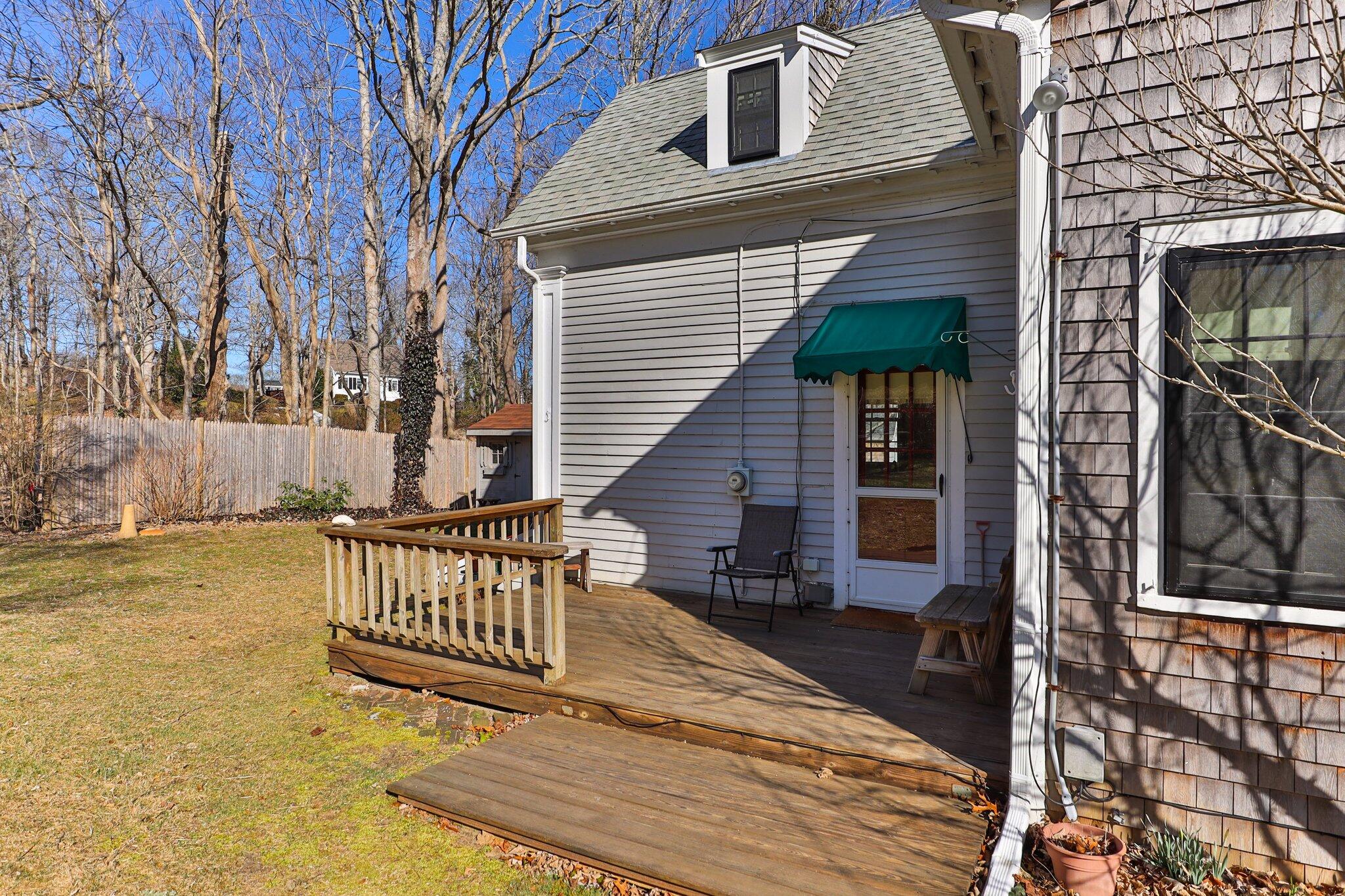12 Childs Homestead Road Orleans, MA 02653 - Photo 26 of 39 a view of a deck with wooden floor and fence with a floor to ceiling window