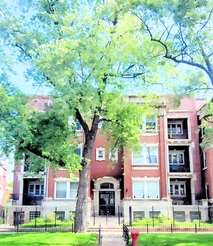 a front view of a building with trees