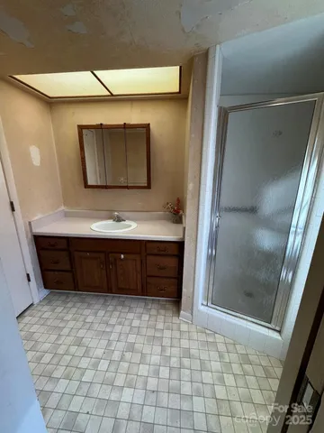 a view of an empty room with a window and fireplace