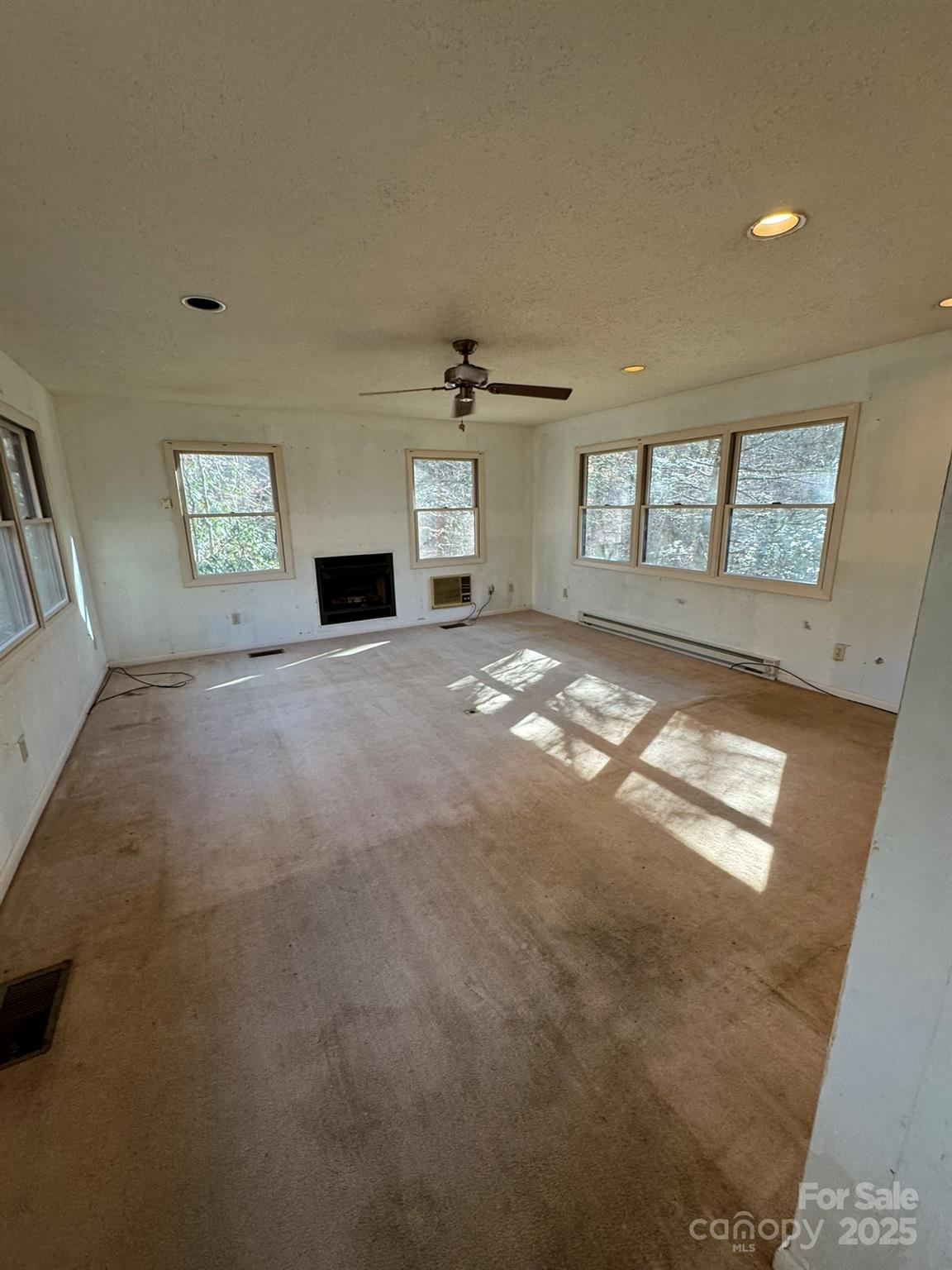 80 Larkspur Lane Cullowhee, NC 28723 - Photo 25 of 34 a view of an empty room with a window and fireplace