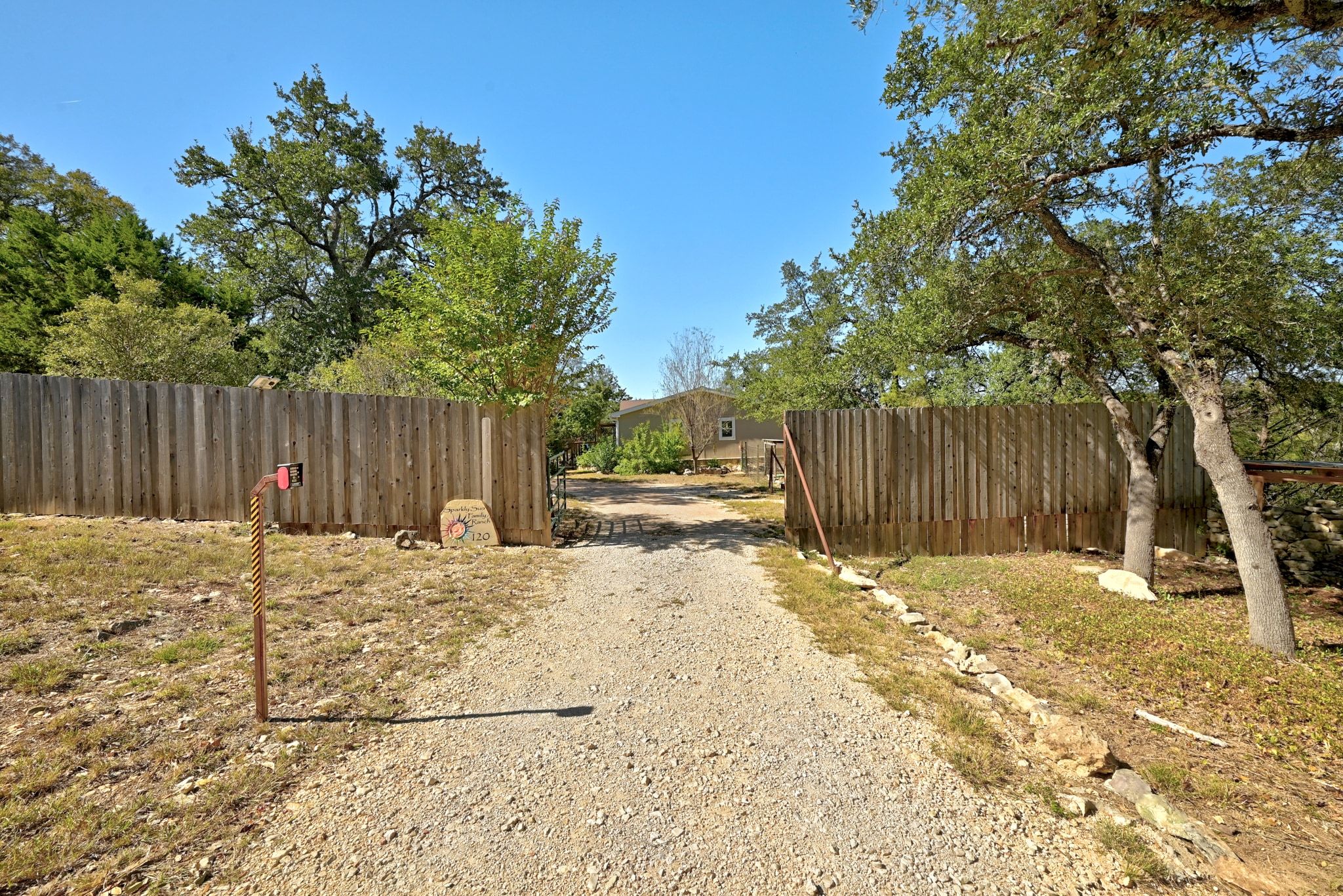 120 Cedar Bend Road Wimberley, TX 78676 - Photo 6 of 40 a backyard of a house with table and chairs and wooden fence