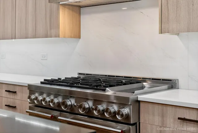 a view of cabinets a sink and a mirror in a room