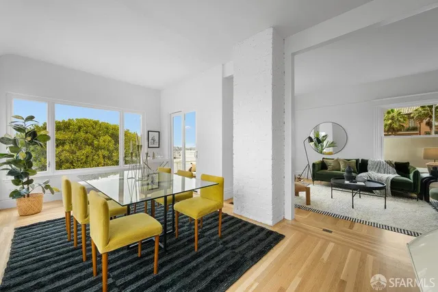 a kitchen with stainless steel appliances granite countertop a stove a sink dishwasher a microwave oven with a dining table and chairs