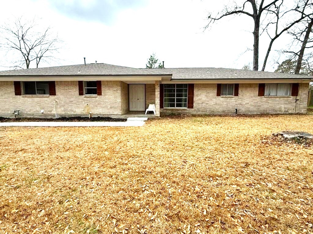 101 Summit Drive Conroe, TX 77303 - Photo 1 of 24 a front view of a house with yard
