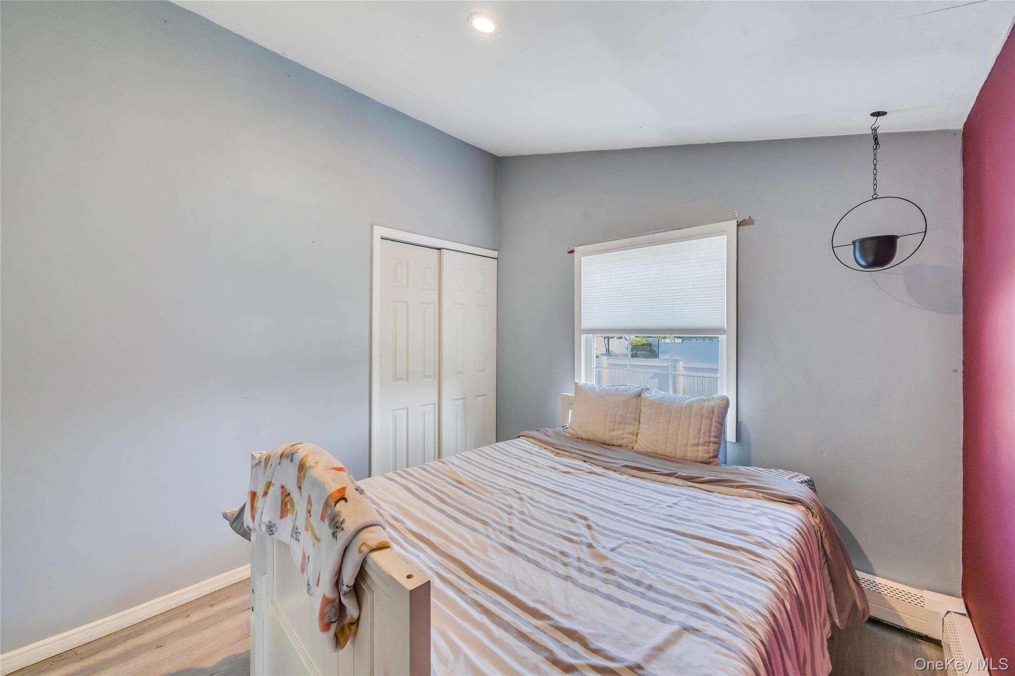 7 Amherst Road Ronkonkoma, NY 11779 - Photo 24 of 36 a bedroom with a bed and a mirror