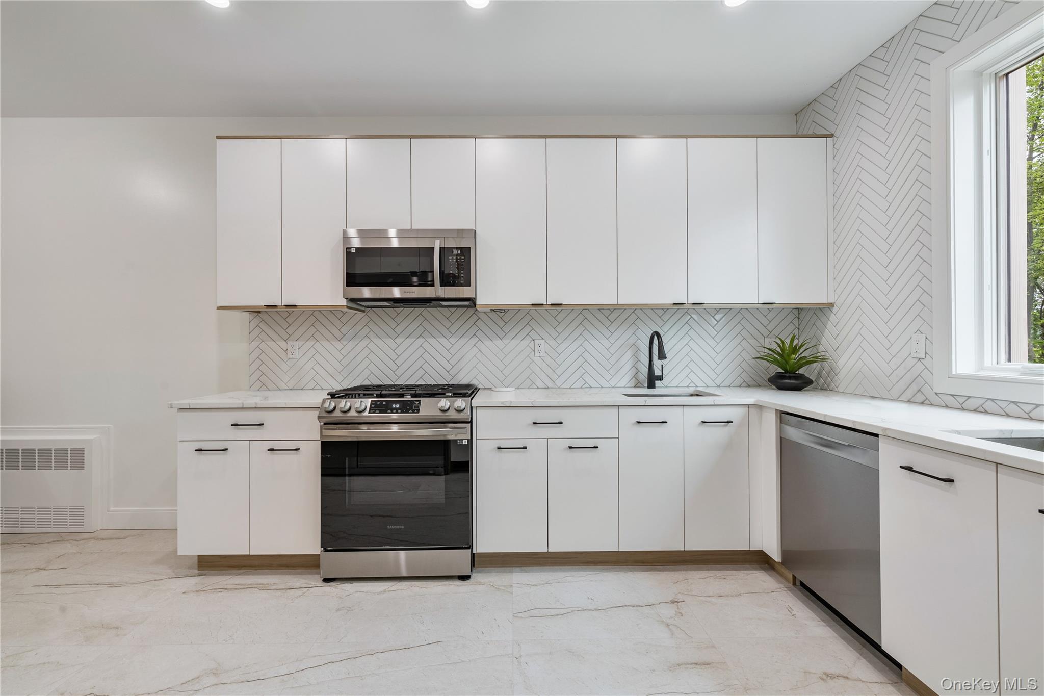 17 Union Road, Unit 206 Spring Valley, NY 10977 - Photo 17 of 41 a kitchen with granite countertop white cabinets and stainless steel appliances