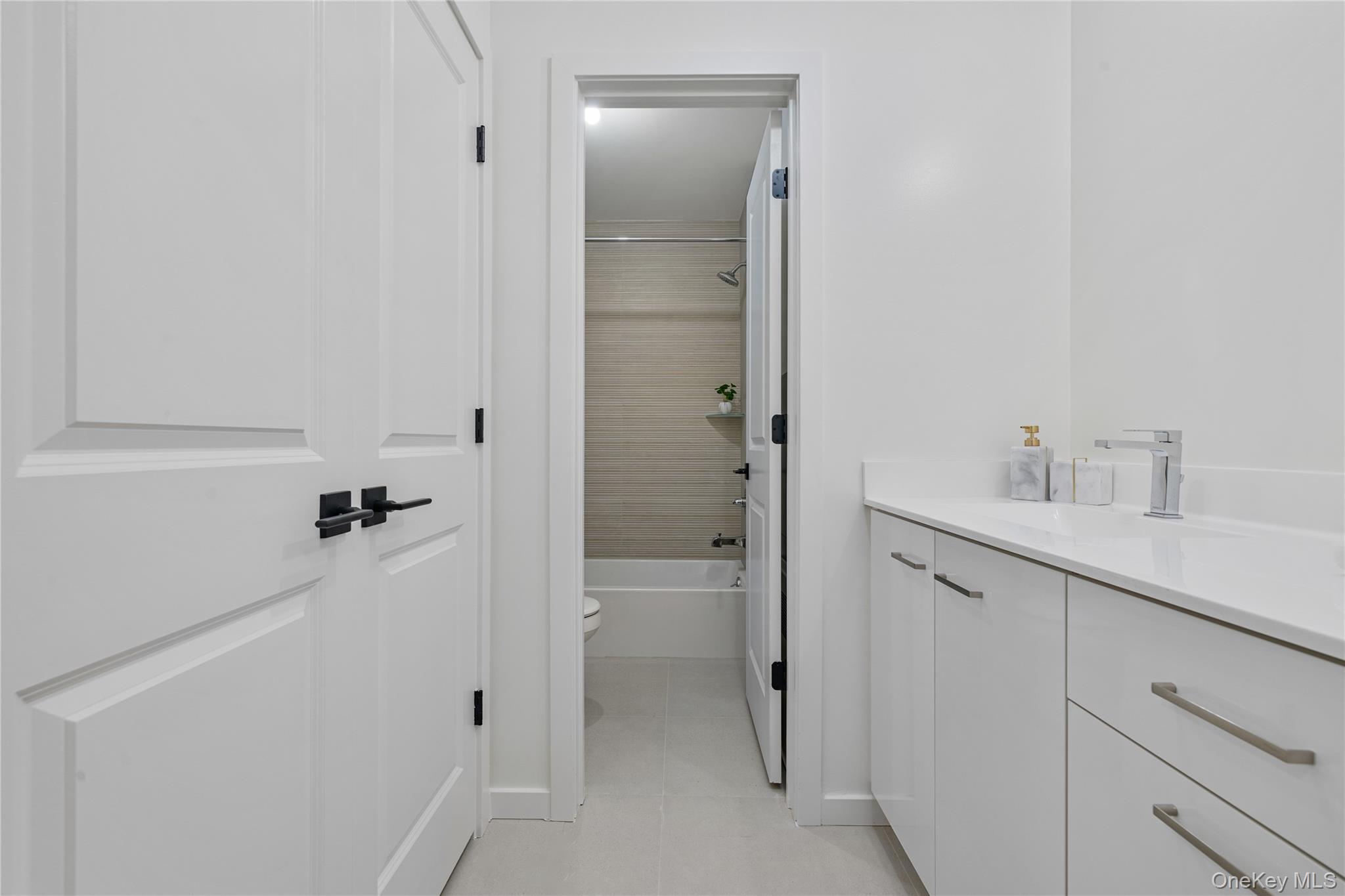 17 Union Road, Unit 206 Spring Valley, NY 10977 - Photo 35 of 41 a bathroom with a shower sink and mirror