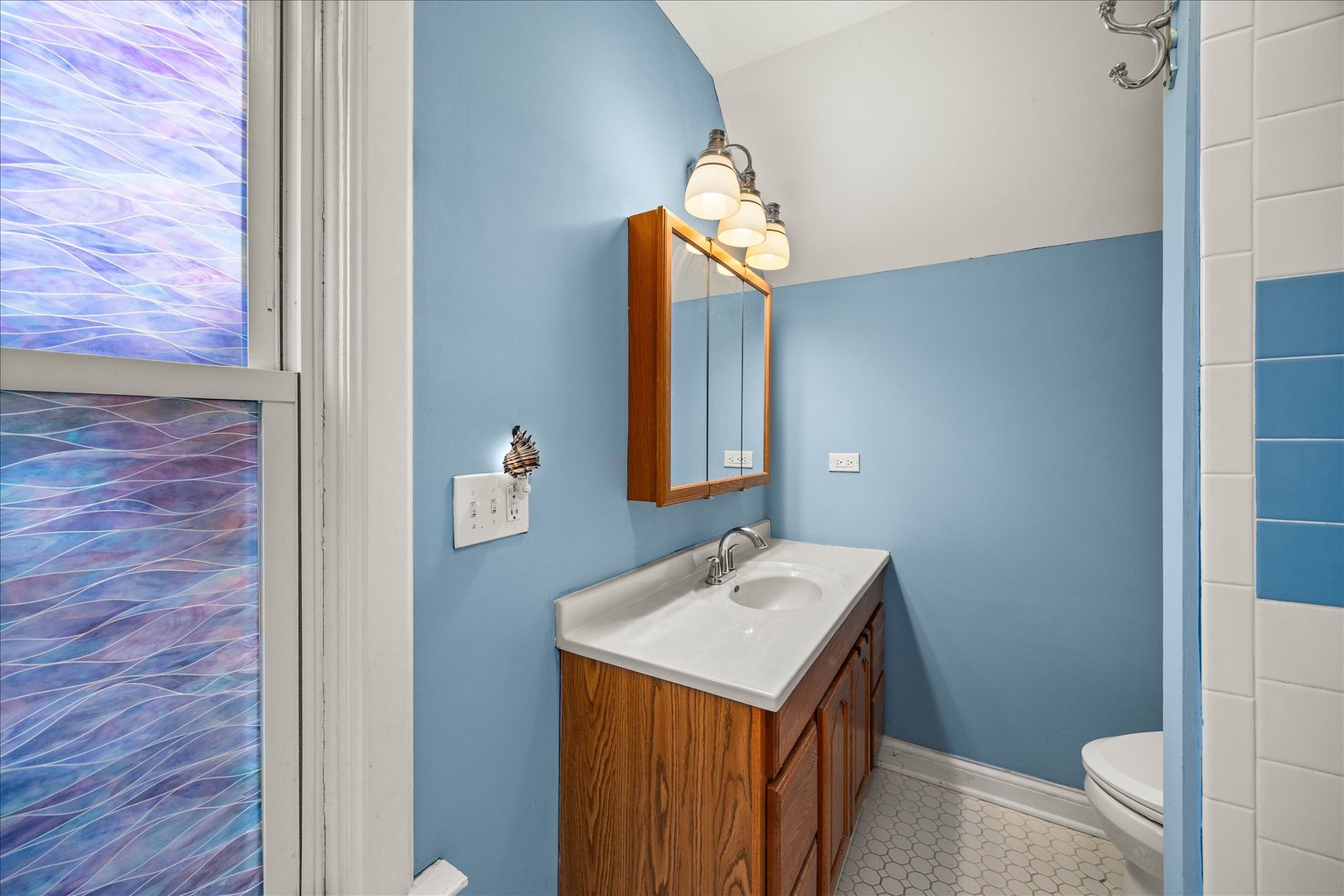 1017 Center Street Elgin, IL 60120 - Photo 16 of 27 a bathroom with a sink and a mirror