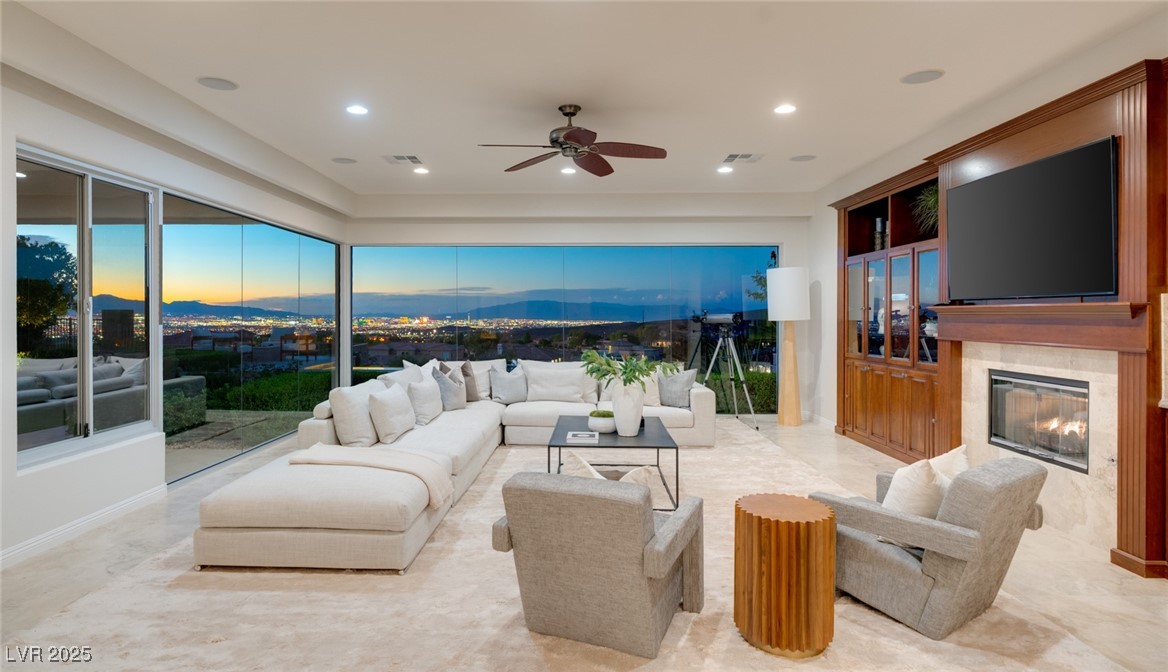 24 Kittansett Loop Henderson, NV 89052 - Photo 15 of 77 The expansive great room is the heart of the home, with walls of glass framing panoramic Strip and mountain views