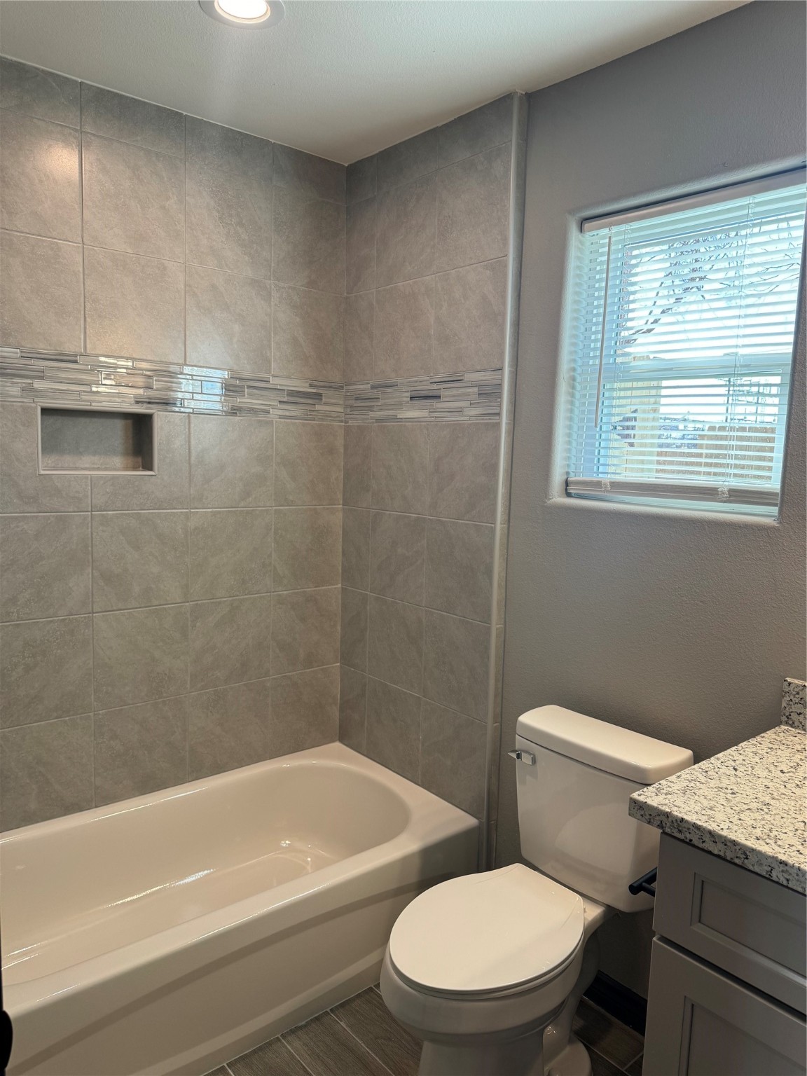 7906 Sexton Street, Unit 2 Houston, TX 77028 - Photo 12 of 14 a white toilet and tub sitting next to a window