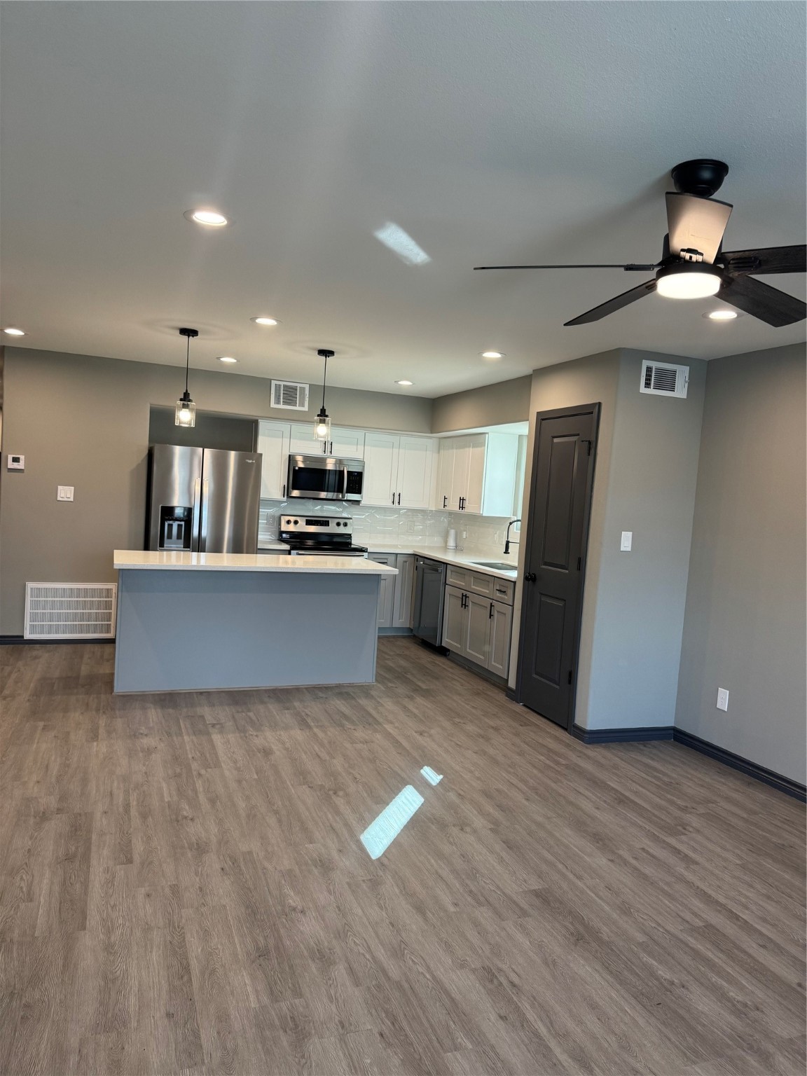 7906 Sexton Street, Unit 2 Houston, TX 77028 - Photo 3 of 14 a large kitchen with stainless steel appliances granite countertop a stove and a refrigerator