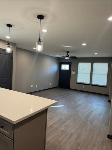 a kitchen with kitchen island white cabinets and black appliances
