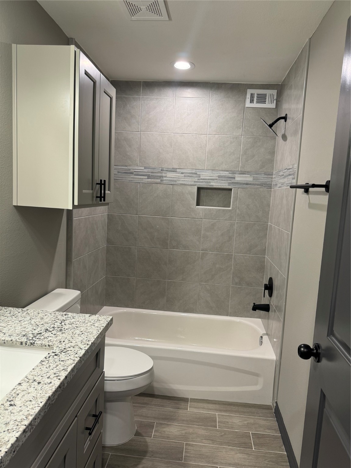 7906 Sexton Street, Unit 2 Houston, TX 77028 - Photo 8 of 14 a bathroom with a granite countertop sink toilet and shower