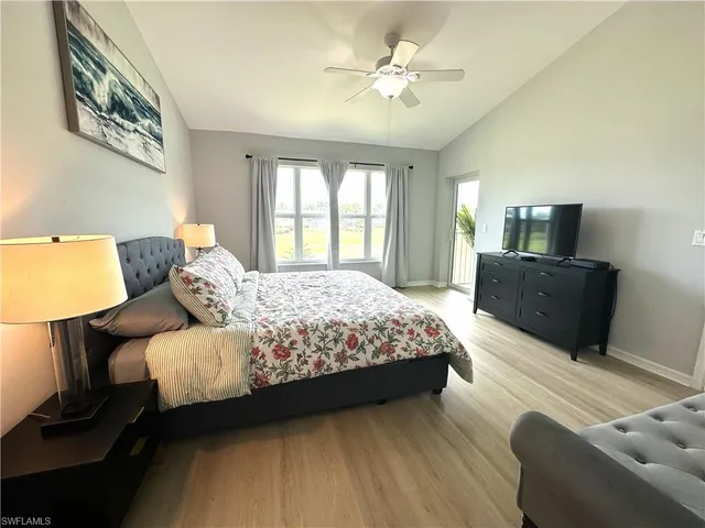 a bedroom with a bed flat screen tv and window