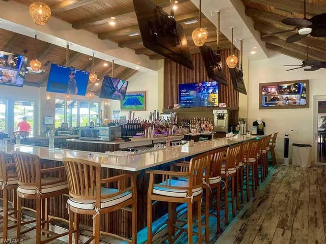 an aerial view of residential houses with outdoor space and swimming pool