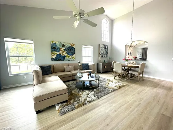 a living room with furniture and a chandelier