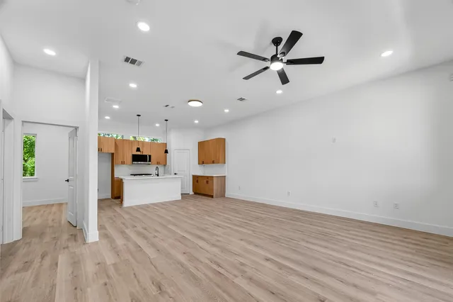 a view of a livingroom with a hardwood floor and a ceiling fan