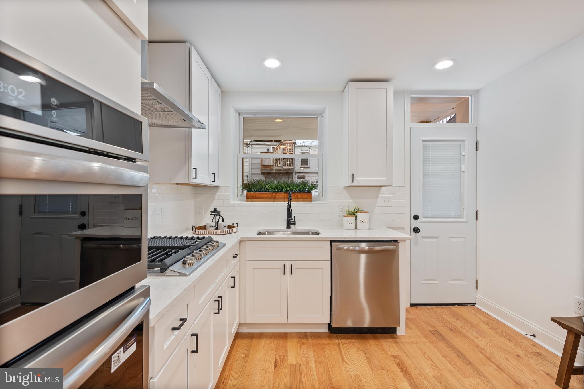 1352 Andre Street Baltimore, MD 21230 - Photo 11 of 52 a kitchen with a sink stove and cabinets