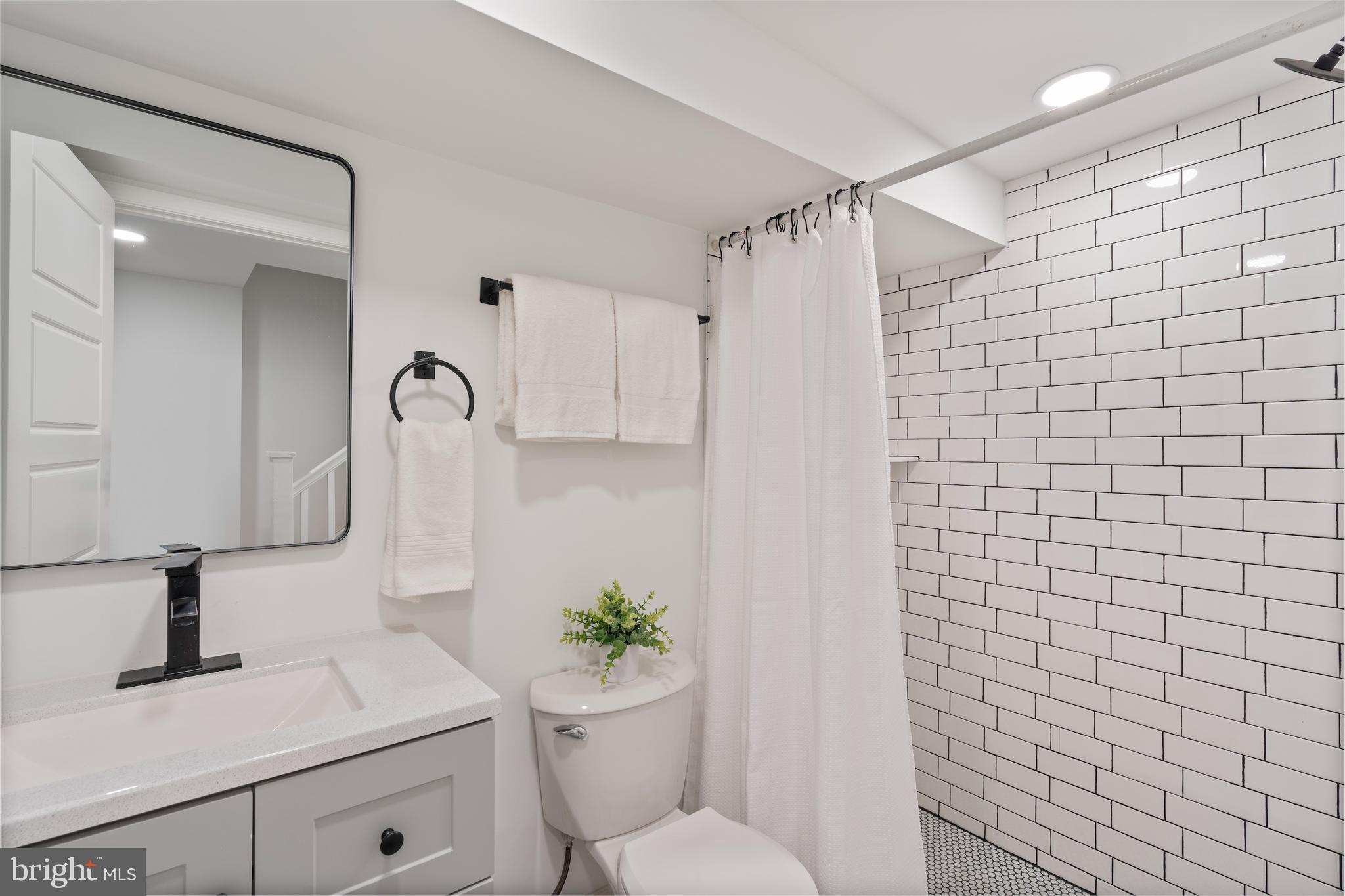 1352 Andre Street Baltimore, MD 21230 - Photo 20 of 52 a bathroom with a sink a toilet and shower