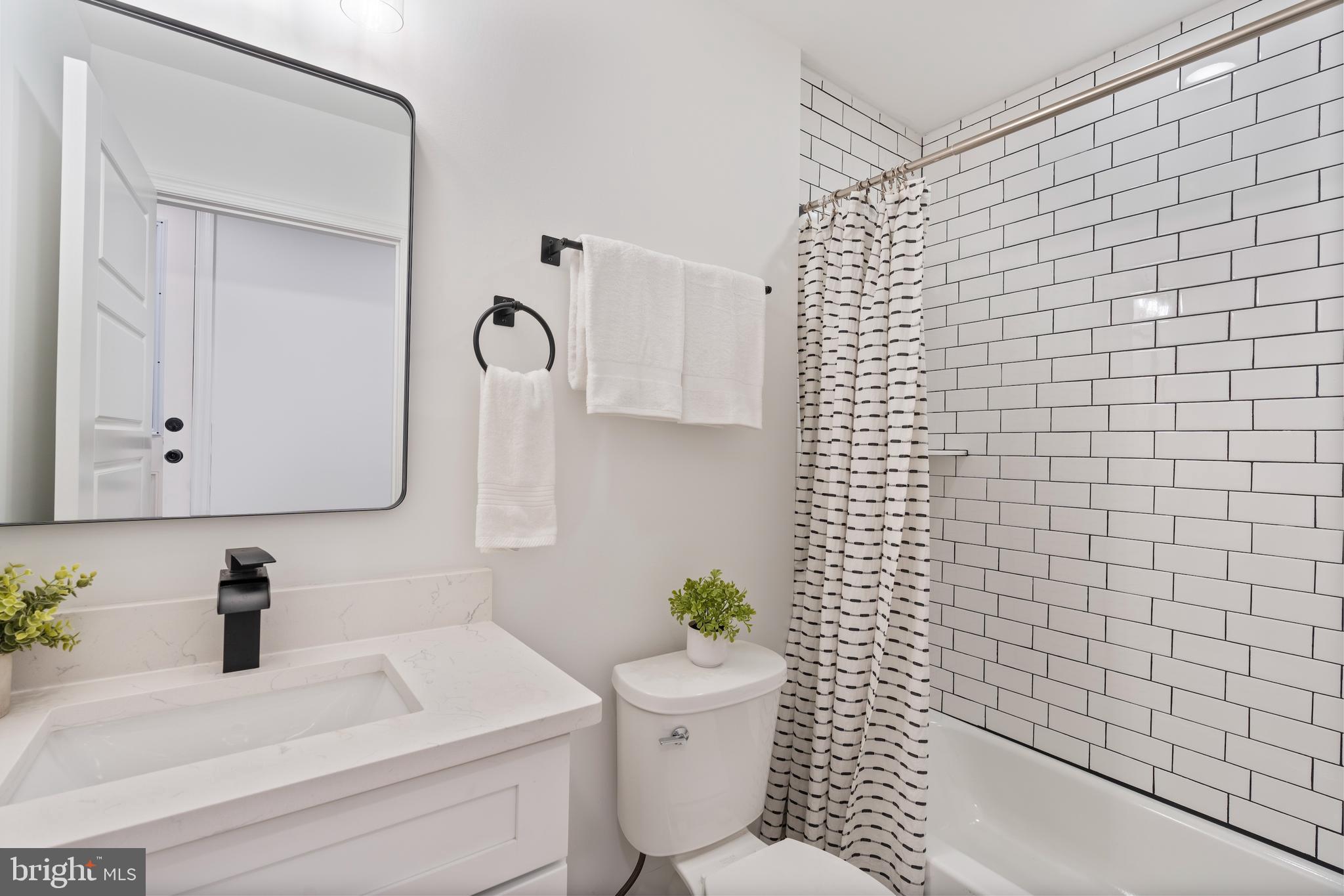 1352 Andre Street Baltimore, MD 21230 - Photo 30 of 52 a bathroom with a toilet sink and mirror