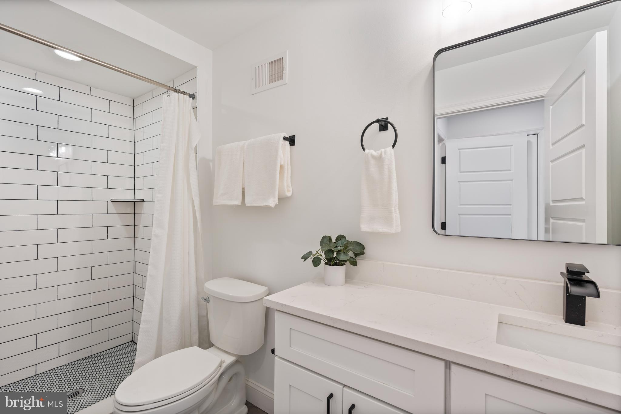 1352 Andre Street Baltimore, MD 21230 - Photo 32 of 52 a bathroom with a sink a toilet and shower
