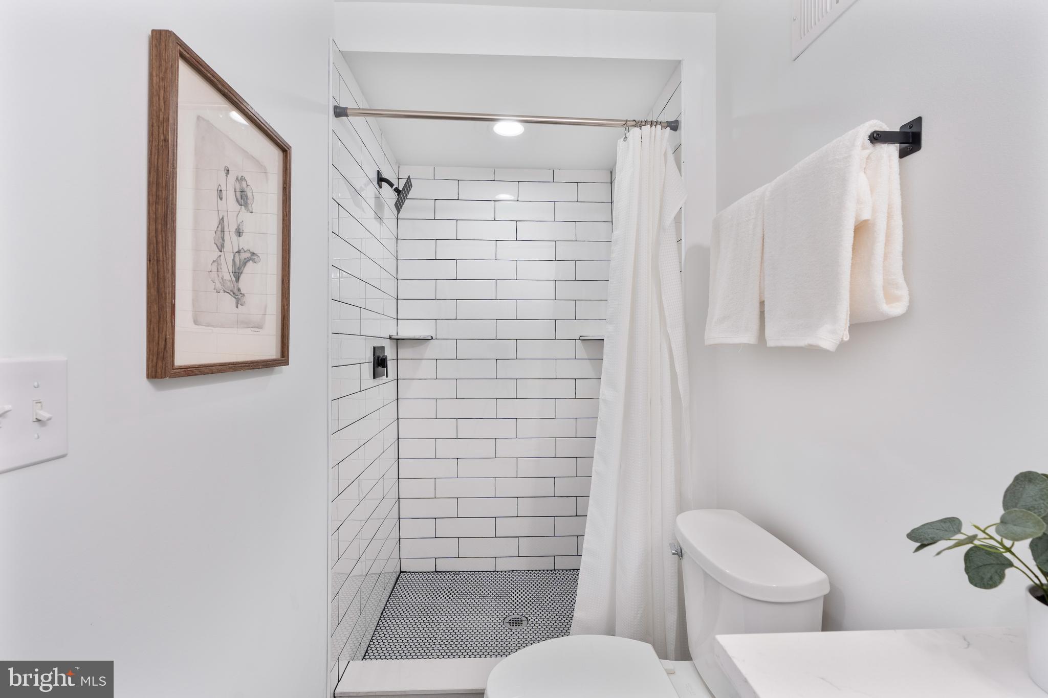 1352 Andre Street Baltimore, MD 21230 - Photo 33 of 52 a bathroom with a toilet and shower