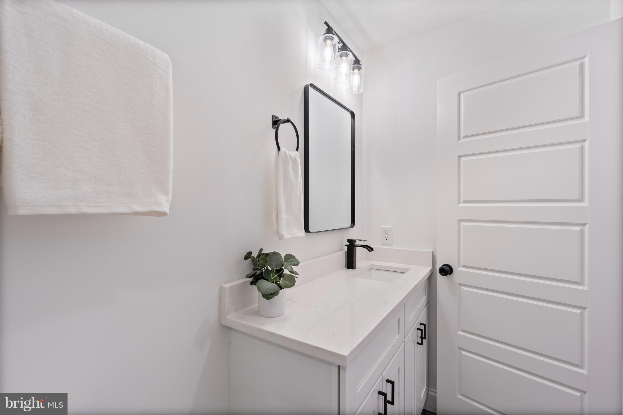 1352 Andre Street Baltimore, MD 21230 - Photo 34 of 52 a bathroom with a sink vanity and a mirror