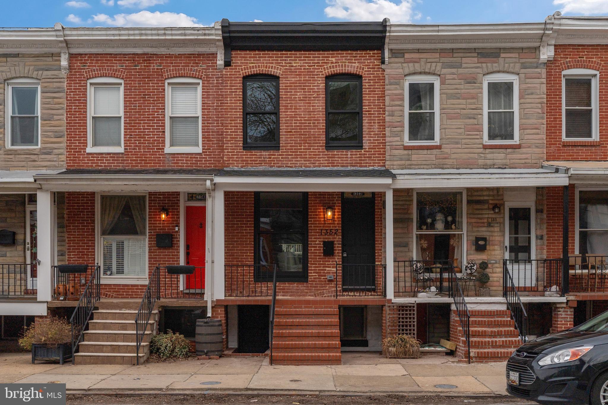 1352 Andre Street Baltimore, MD 21230 - Photo 46 of 52 a front view of a building with a window and cars parked