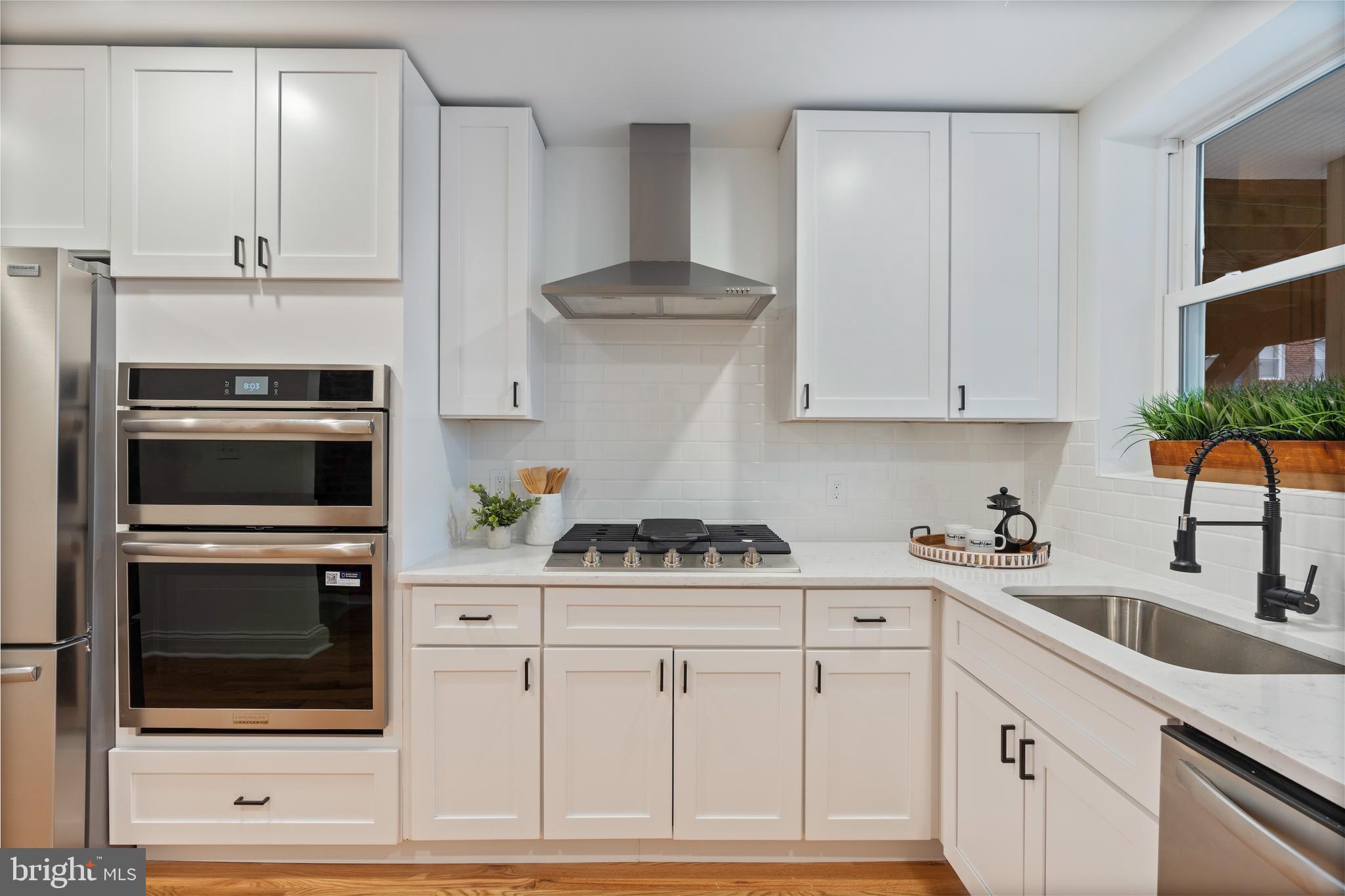 1352 Andre Street Baltimore, MD 21230 - Photo 10 of 52 a kitchen with stainless steel appliances white cabinets and a stove a sink