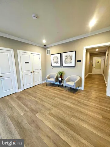 a spacious bedroom with a bed and wooden floor