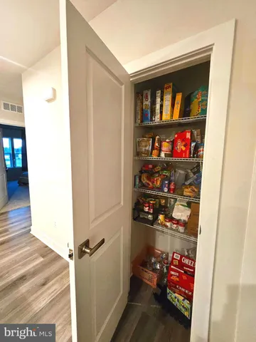 a view of a balcony with food on wooden floor and city view