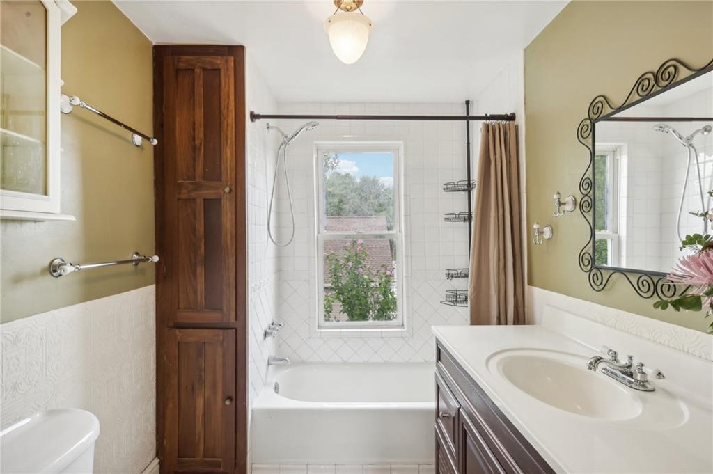 313 Pine Street Zelienople, PA 16063 - Photo 23 of 42 a bathroom with a granite countertop sink a mirror a bathtub and shower